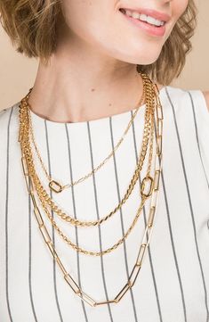 Mixed chains style a four-layer necklace that's perfect for a chic look. Modern Gold Chain Necklace For Layering, Gold Long Necklace For Layering, Elegant Double Strand Layered Necklace With Chunky Chain, Gold Layered Long Necklace, Multi-strand Chain Jewelry For Layering, Gold Layered Clavicle Chain Necklace For Formal Occasions, Chic Gold Double Strand Chain Necklace, Chic Gold Double Strand Necklaces, Elegant Double Chain Link Layered Necklace