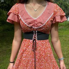 Pretty Little Red Gingham And Calico 1970s Jody T Prairie Dress! Jody T Always With The 70s Stunners And This One Is No Joke. Super Cute Mixed Prints Poly Cotton Pink And Red With The Little Pop Of Green, Perfect Layered Ruffle Sleeves And Contrasting Black Middle Corset With Tie Back Waist. Zips Up The Back, No Pockets. No Flaws To Note. No Size Tag, Measures Like A Vintage 7 Bust 32 Waist 26 Length 54 #Jodyt #Vintageprairiedress #Prairiedress #70sdress Fitted Retro Vintage Dress For Picnic, Fitted Gingham Retro Vintage Dress, Retro Fitted Gingham Vintage Dress, Fitted Vintage Gingham Dress In Retro Style, Fitted Gingham Vintage Dress, Red Retro Vintage Dress For Spring, Retro Gingham Mini Dress, Fitted Gingham Cottagecore Dress, Retro Plaid Dresses With Ruffles