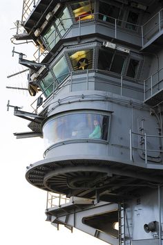 an airplane is sitting on top of a large building that has stairs going up to it