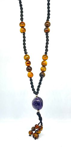 Namaste🙏❤️🙏 This Nacklace is made with genuine real (tiger eye,s ,amethyst) gemstone and black polyester threads using my skills to put love into it. macrame is an art to make boho jewellery. We used in this 27 beads of tiger eye gemstone approx 9mm, A tumble of amethyst gemstone approx 16mm and 9 beads of tiger eye gemstone approx 6mm. TIGER EYE:- Tiger Eye attracts good luck and prosperity, particularly suitable for men and women born under the zodiac signs of Capricorn and Leo. It amplifies their positive qualities and helps minimize the negative traits associated with these signs. It boosts self-confidence and assertiveness, making it beneficial for individuals seeking personal growth and development. Tiger Eye balances energy centers, it is associated with the solar plexus chakra, w Amber Beaded Necklace For Meditation, Amber Bead Necklace 8mm As Gift, Amulet Style Necklace With 8mm Beads For Gift, Handmade Amethyst Pendant Beaded Necklaces, Handmade Amethyst Pendant Beaded Necklace, Amber Necklaces With 8mm Beads For Gift, Amber Necklace With 8mm Beads For Gift, Handmade Amber Crystal Necklace For Meditation, Handmade Spiritual Amber Beads, Gems, And Cabochons