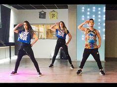 three young women are dancing on the dance floor