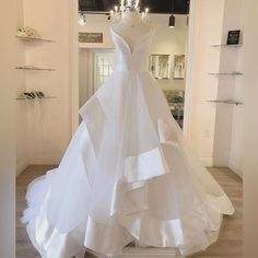 a white wedding dress on display in a store