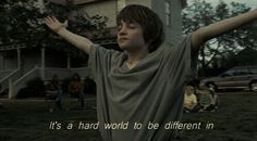 a young boy holding his arms out in front of him with the words, it's a hard word to be different in