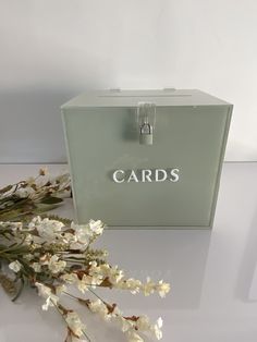 a card box sitting on top of a table next to flowers