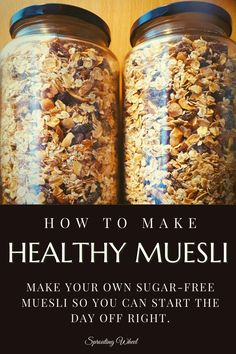 two jars filled with granola sitting on top of a wooden table next to a sign that says how to make healthy muesli