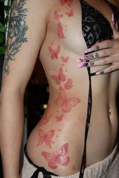 a woman with butterfly tattoos on her back and chest is holding a cell phone in her hand