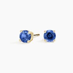 Solitaire Sapphire Stud Ears - 18K Yellow Gold. A beautifully matched pair of brilliant blue sapphires are secured in classic four-prong basket settings with comfortable push back posts for pierced ears. Classic Round Tanzanite Earrings, Classic Yellow Gold Jewelry With Lab-created Sapphire, Classic Yellow Gold Lab-created Sapphire Jewelry, Classic Blue Brilliant Cut Earrings, Classic Sapphire Birthstone Earrings, Gold Sapphire Earrings With Prong Setting, Anniversary Yellow Gold Sapphire Earrings, Classic Sapphire Earrings In 14k Gold, Classic 14k Gold Sapphire Earrings