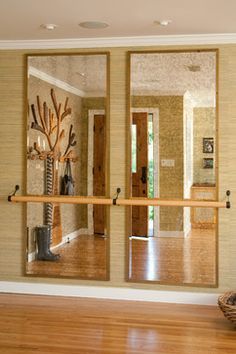 the reflection of a tree in two mirrors is shown on the wall next to an open door