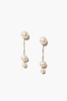 A modern take on the classic pearl, these 18k gold plated sterling silver drop earrings feature two petite graduated freshwater pearls hanging from a paperclip chain with pearl post. A timeless design perfect on its own or paired with dainty earrings.18k gold plated sterling silver.2" drop.Handmade in Vietnam. White Gold Drop Earrings With Pearl Charm, Luxury Delicate Drop Pearl Earrings, Timeless Pearl Charm Drop Earrings, Luxury Pearl Chain Drop Earrings, Chan Luu Pearl Earrings, Unique Pearl Earrings, Freshwater Pearl Drop Earrings, Unique Handmade Earrings, Hammered Hoop Earrings