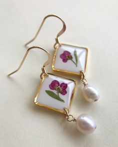 Wildflower Dangle Earrings with Pearls. Each piece contains a single Alyssum flower stem and leaf. They are carefully arranged and conserved in layers of white and clear resin. Freshwater pearls add a classy/vintage look to them. Choose from either a french wire hook, or a kidney wire hook. Available in two colors. Approx. length is 1 ¼ inches. Keep in mind that no two flowers are exactly the same so your piece will be truly one-of-a-kind! I try to make each piece so that it resembles the photo. Classic Flower Shaped Jewelry With Matching Earrings, Classic Flower-shaped Jewelry With Matching Earrings, Classic Floral Jewelry With Matching Earrings, Floral Birth Flower Earrings For Anniversary, Delicate Birth Flower Earrings For Anniversary, Birth Flower Earrings For Anniversary, Minimalist Flower-shaped Formal Jewelry, Anniversary Birth Flower Earrings, Delicate Teardrop Flower Earrings For Anniversary