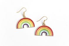 "These sweet rainbow earrings can't wait to spruce up your festival outfit with some serious retro-boho charm! Earring hooks are hypoallergenic. ▲ Rainbow charms measure approx. 1\" x 1 1/8\" ▲ Gold-plated surgical steel earring hooks (hypoallergenic) We try to display product colors as close to life as possible. However, all computer monitors are different and so there might be slight color variations from screen to screen. If you have any questions, feel free to contact us! CARE INSTRUCTIONS J Rainbow Drop Earrings As A Gift, Rainbow Nickel-free Earrings For Gifts, Cute Multicolor Jewelry With Ear Wire, Rainbow Nickel-free Drop Earrings, Nickel-free Rainbow Earrings For Gift, Nickel-free Rainbow Earrings Gift, Cute Multicolor Dangle Jewelry, Nickel-free Rainbow Drop Earrings, Cute Multicolor Jewelry