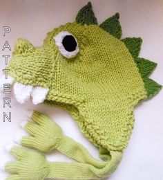 a green knitted hat and mitten with a fish on it