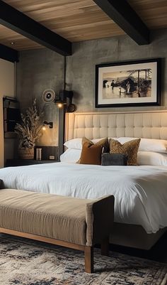 a bedroom with a large bed sitting next to a painting on the wall above it