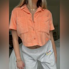 Ugg Brand: Bright Orange/Peach Button Down Terry Cloth Shirt; Short Sleeved And Cropped New With Tags Size Small Let Me Know If You Have Any Questions! :) Casual Loungewear Shirt With Button Closure, Casual Loungewear Shirt, Casual Buttoned Shirt For Loungewear, Short Sleeve Tops With Button Closure For Loungewear, Trendy Button-up Top With Pockets, Trendy Collared Cropped Shirt With Buttons, Pink Button-up Shirt For Loungewear, Collared Shirt With Buttons For Loungewear, Trendy Cropped Short Sleeve Shirt With Buttons