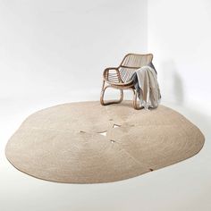 a chair sitting on top of a rug next to a white wall