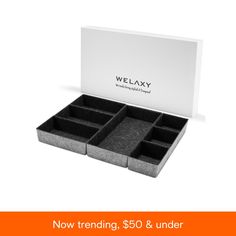 an open box with compartments for jewelry