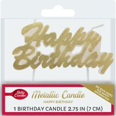 a birthday candle with the words happy birthday in gold foil on it's side