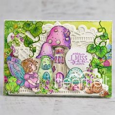 a card with an image of a fairy house