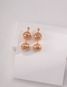 Elegant Matte Gold Earrings For Party, Elegant Matte Gold Party Earrings, Elegant Silver Orb Earrings, Gold Round Linear Earrings For Party, Gold Sphere Earrings For Party, Glamorous Gold Linear Earrings As Gift, Gold Orb Earrings, Glamorous Gold Linear Earrings For Gift, Matte Gold Drop Earrings For Party