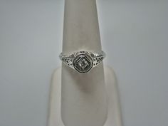 "For Sale: (1) H108 Gorgeous Diamond Ring in 14k White Gold from 1930's PLEASE READ ENTIRE DESCRIPTION BEFORE PURCHASING Please see pictures for more details! This stunning ring features a center 0.06 ct diamond. This is a beautiful filigree mounting down the side. The shank is decorated half way down. The ring is not stamped 14k, but was tested for it. This ring is from the 1930's. A beautiful piece for a any special occasion! What a great Gift! Specifics: *14k White Gold *Center Diamond approx Collectible Heirloom Solitaire Ring, Vintage White Gold Signet Ring With Center Stone, Classic Diamond Signet Ring Collectible, Vintage Solitaire Signet Ring, Vintage Diamond Cut Signet Promise Ring, Collectible Classic Diamond Signet Ring, Vintage Diamond Solitaire Signet Ring, Vintage Diamond-cut Signet Promise Ring, Vintage Oval Diamond Cut Signet Ring