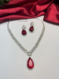 Gorgeous fine quality imitation jewellery red faux diamonds studded necklace with white gold rhodium plating and matching Earrings Item contains: Necklace and earrings Highest quality and craftsmanship Necklace Fitting is adjustable Earrings Closure: Pushback Necklace Closure: chain with Hook Details-  -Handmade item -Delivery from a small business in India -Materials: white rhodium, stones, cz, zircon, American diamond -Jewellery type: Earrings, Necklace -Style: Art deco *CARE INSTRUCTION* You can use Jewelry for years together with the help of below jewelry care instructions. * Protect from sharp blows/scratches and extreme temperature. * Avoid contact with perfumes, sprays, chemicals and water. * Keep in a clean, dry and airtight Zip-pouch. * Wipe it using a soft cloth after each use. Red Diamond Necklace, Affordable Necklaces, Necklace Closure, Pendant Earrings Set, Indian American, American Diamond Jewellery, Studded Necklace, Diamond Jewelry Necklace, Jewelry Care Instructions