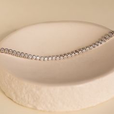 Your wedding day is a time for you to sparkle and be the center of attention. Accentuate your romantic ensemble with our Diamond Bezel Tennis Bracelet. Available in 3 lengths, this minimalist gemstone bracelet can be chosen based on the fit you need, making it an even more personalized bridal gift. Finish/Material: 18K Gold Over Brass ∙ Rhodium Over Brass Featuring ~3mm Bezels with ~2mm CZ Diamond Stones Part of our Diamond & Pavé Collection Model showcases a glamorous, statement look featuring Initial Tag Necklace, Dainty Initial Necklace, Bracelet Tennis, Bridal Gift, Twist Ring, Domed Ring, Tennis Bracelet Diamond, Bezel Diamond, Cz Diamond