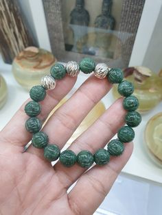 Gift idea 🎁! Deep green Jade beads, 10.5 mm size, engraved with Ruyi swirls to invite  good fortune; Fei Cui, Type A natural Jadeite (non-bleached, non-dyed, non-treated materials) of glossy deep green color, each finely detailed. This Ruyi Bracelet is charmed with 3 pieces of beautifully chiselled Sterling Silver Beads, 10.5 mm size. Bracelet size 17 cm, weighs 36 grams (more or less); may be upsized (to 18 cm) or downsized upon request. To request for resize, you may send us a direct message Adjustable Carved Bracelets With Round Beads, Green Spiritual Bracelets With Large Beads, Green Carved Bracelet As A Gift, Green Carved Bracelets As Gift, Traditional Green Beaded Bracelets With 8mm Beads, Green Carved Bracelet For Gift, Traditional Green Jade Beaded Bracelets, Green Beaded Bracelets With Large Beads, Spiritual Carved Round Beads Bracelets