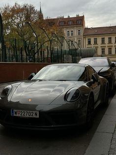 two cars parked next to each other on the street