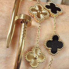 3 Gold Bracelets. Stainless Steel Double Sided Clovers. Hypoallergenic Water Resistant Alhambra Style. Nail Bangle Bracelet. Stainless Steel As Well. Van Cleef And Arpels Jewelry Black, Luxury Black Tarnish-resistant Bracelet, Van Cleef Alhambra, Nail Bangle, Stacked Bracelets, Clover Jewelry, Black Bracelet, Gold Bracelets, Black Bracelets