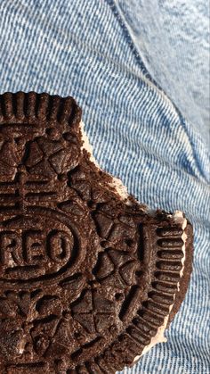 an oreo cookie with the word red on it's side, sitting on top of a blue cloth