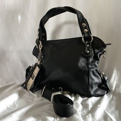 Easspaulo Black Satchel; Nwt; Gold Hardware; Zipper Closure; Two Handles And Detachable Shoulder Strap; Exterior Zippered Pocket; Interior Zippered Large Compartment And Several Smaller Compartments; Side Buckle And Hanging Leather Fringe Embellishments; Approximate 12" Height; 14" Width (Across Bottom Of Bag) Reasonable Offers Are Always Welcome. Casual Crossbody Satchel With Silver-tone Hardware, Black Crossbody Shoulder Bag With Silver-tone Hardware, Black Leather Hobo Bag With Adjustable Handle, Black Satchel With Silver-tone Hardware For Travel, Everyday Black Satchel With Silver-tone Hardware, Casual Travel Satchel With Silver-tone Hardware, Black Trendy Satchel With Silver-tone Hardware, Black Hobo Bag With Adjustable Strap For Travel, Black Hobo Bag With Silver-tone Hardware, Tote Shape