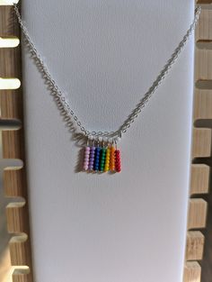 Welcome to our little corner of the internet, where we create unique and beautiful jewelry pieces made with love and care by queer hands. Our newest listing, the silver necklace with rainbow fringe pendant, is perfect for anyone looking for a subtle way to show their queer pride. Crafted with high-quality materials, this necklace features a beautifully designed silver pendant that is both elegant and understated. The pendant is adorned with a colorful fringe of rainbow hues, creating a gorgeous contrast that is sure to turn heads. As a queer-owned independent small business, we take great pride in creating jewelry that reflects our values and experiences. By purchasing this necklace, not only will you be adding a stunning piece to your collection, but you will also be supporting a queer ar Rainbow Fringe, Fringe Necklace, Creating Jewelry, Pride Flag, Lgbt Pride, Design Silver, Pride Flags, Wire Wrapped, Silver Pendant