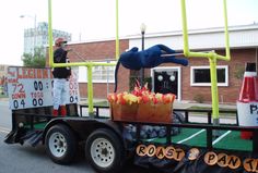 a man standing on the back of a truck filled with fruit