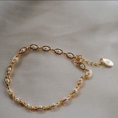 Our Pippa Pearl Bracelet is dainty + modern! What do we love about it? The tiny pearl accents add just a touch of traditional style in a modern way! This bracelet is perfect for any bridal event but can also be worn any time of the year or for any occasion which makes this the perfect gift! BRACELET FEATURES Materials: Brass, 14K Gold, Rhodium, Faux Pearl Finish: Choice of Yellow Gold or Rhodium Plating Dimensions: 6.5" with a 2" extender (can be worn up to 8.5") 14K gold-filled or sterling silv Elegant Metal Chain Bracelet With Pearl, Elegant Metal Bracelets With Pearl Chain, Elegant Metal Bracelet With Pearl Chain, Dainty Silver Bracelet With Pearl Chain, Feminine Adjustable Beaded Bracelets For Wedding, Wedding Pearl Bracelet With Metal Charm, Elegant Charm Bracelet For Wedding, Classic Adjustable Chain Bracelet With Pearl Charm, Elegant Beaded Metal Bracelets With Pearl Charm