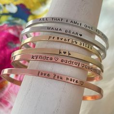 four different types of bracelets with words on them, all that i am one to mama bear