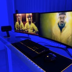 two computer monitors sitting on top of a desk