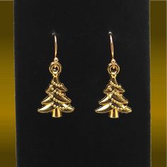 ABOUT THIS ITEM > Gold Christmas Tree Charms > Gold Plated Solid 925 Sterling Silver (stamped) Ear Wires    Christmas Jewelry  Gold Christmas Trees Hypoallergenic & Nickel Free Ear Wires        Lightweight - Durable - Comfortable ✅ Great for everyday wear! Great for children or adults!       ✧ Christmas Tree 🎄Charms ✧ Height:   3/4 inch  (20mm) Width:     1/2 inch  (13mm) Drop Length:  1 1/4 inches  (32mm) ☞ Earrings are shipped with a pair of very comfortable, easy to use, silicone push backs. Christmas Celebration Jewelry Drop Earrings, Christmas Celebration Drop Earrings Jewelry, Christmas Celebration Jewelry With Matching Earrings, Christmas Gift Drop Earrings, Gold Earrings For Holiday And New Year, Gold Earrings For New Year Holiday, Holiday Dangle Jewelry With Matching Earrings, Holiday Jewelry With Matching Dangle Earrings, Christmas Jewelry Gift With Matching Earrings