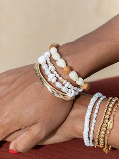 "Flaunting a mix of natural puka shells, luminous white pearls, and 14kt gold filled beads, this handmade Hawaiian shell bracelet acts as an exquisite reminder of the tranquil nature of Hawaii's calming waters. ✦ Choose from two sizes: Mini and Chunky ✦ ✦ DETAILS ✦ ✧ Name: Maka - (MAH kah) - favorite one. ✧ Adjustable Length from: 6.5\"-8\" ✧ Mini: 6-7mm width; Chunky: 9-10mm width. ✧ White Freshwater Pearls. ✧ Puka Seashells. ✧ 14kt Gold Filled Components, Extender, and Clasp. ✧ All Ke Aloha Je Adjustable White Stretch Bracelet With Beachy Style, White Adjustable Stretch Bracelet With Beachy Style, White Hand-strung Bracelets For Beach, Adjustable White Pearl Bracelet For Beach, White Adjustable Beachy Stretch Bracelet, White Hand-strung Beaded Bracelets For Beach, White Hand-strung Beaded Bracelet For Beach, White Beaded Beachy Bracelet, White Shell Beachy Bracelets