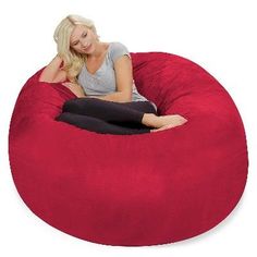 a woman sitting in a large red bean bag chair