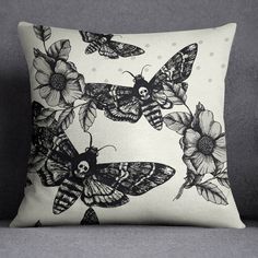 a black and white pillow with butterflies on it