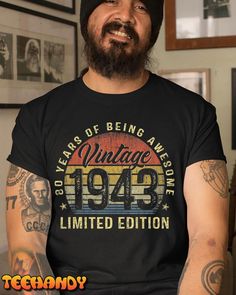 a bearded man wearing a black vintage t - shirt