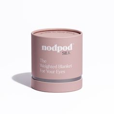 a round pink container with the lid closed and label on it that says, the weighted blanket for your eyes