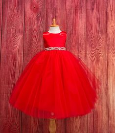 Red 4 Layer Tulle-Ankle Length Dress  This classic beautiful, elegant dress is one of my favorite! So modern and classy for any special occasion. The bodice is made of Red bridal satin, a hidden zipper can be found on the back of the dress, followed by an elegant rhinestone band at the waistline (not removable) The skirt consist of 4 Red Tulle layers and two layers of lining followed by crinoline for a fuller look. If you are interested in a specific color to match your color scheme please message me! Dress is pictured with Petticoat to show full detail. NOT INCLUDED https://www.etsy.com/listing/1305138635/white-ankle-length-petticoat-wedding?click_key=79499b8045349abec4d15e286ce2a8958c22127e%3A1305138635&click_sum=143c4c83&ref=shop_home_active_2&sts=1 Visit our store, more items to come! Elegant Christmas Princess Dress In Tulle, Elegant Christmas Tulle Princess Dress, Elegant Christmas Tulle Tutu Dress, Elegant Christmas Tutu Dress In Tulle, Elegant Tulle Ball Gown For Christmas, Elegant Christmas Tulle Ball Gown, Holiday Wedding Tulle Princess Dress, Princess Style Christmas Wedding Ball Gown, Christmas Wedding Princess Ball Gown