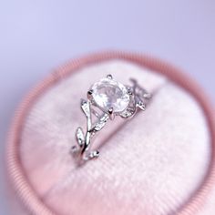 an engagement ring in a pink velvet box