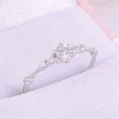 a diamond ring sitting on top of a white cloth