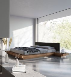 a modern bedroom with large windows and white walls