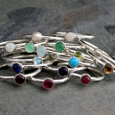 Create your own unique set of stacking rings. Select a stacking ring to represent your birthday or the birthdays of the ones you love. Or, create your own colorful set by mixing and matching your favorite colors and gemstones. The gems are 4mm. Set in solid sterling silver. Birthstone: January - Garnet February - Amethyst March - Aquamarine April - Clear Topaz May - Green Onyx June - Pearl July - Lab Ruby August - Peridot September - Lab Sapphire October - Lab Opal November - Citrine December - Adjustable Nickel-free Stackable Rings For Gifts, Spiritual Gemstone Stackable Rings As Gift, Handmade Spiritual Birthstone Ring Gift, Spiritual Handmade Birthstone Ring Gift, Silver Stackable Birthstone Rings For Birthday, Handmade May Birthstone Stackable Rings As Gift, Handmade Birthstone Ring Gift With Round Stone, Sterling Silver Stackable Rings, May Birthstone Gift, Handmade Birthstone Ring With Round Stone As Gift