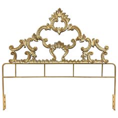 a gold metal headboard with ornate designs