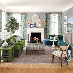 a living room filled with furniture and a fire place in front of a window covered in curtains