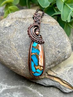 This stunning Spiny Oyster Copper Turquoise Stone with splashes of Turquoise and orange has been wrapped in Handwoven Copper and dangles from an adjustable 16-18 inch copper chain.  A patina process was applied to give this piece a rich, antiqued look.  This beautiful statement piece would be a great addition to any wardrobe. Artisan Turquoise Hand Wrapped Necklaces, Artisan Hand Wrapped Turquoise Necklaces, Artisan Hand Wrapped Turquoise Necklace, Handmade Turquoise Copper Wire Necklace, Handmade Turquoise Necklace With Copper Wire, Turquoise Necklace With Copper Wire, Handmade Copper Turquoise Necklace, Handmade Turquoise Copper Necklace, Turquoise Copper Wire Necklace Gift